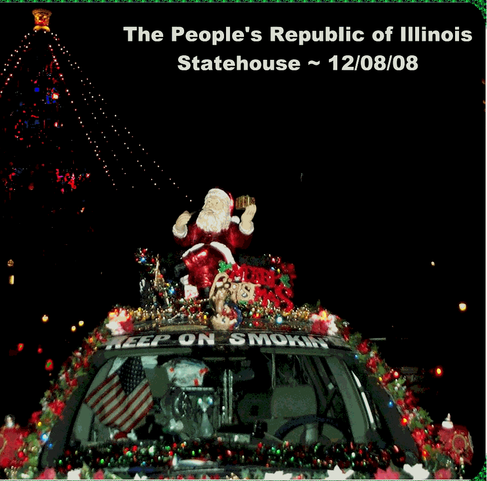 close up front photo of Liberty Van with Christmas lights and decorations at night, at Illinoie statehouse Capitol in Springfield IL.  Santa is on the roof with his pipe