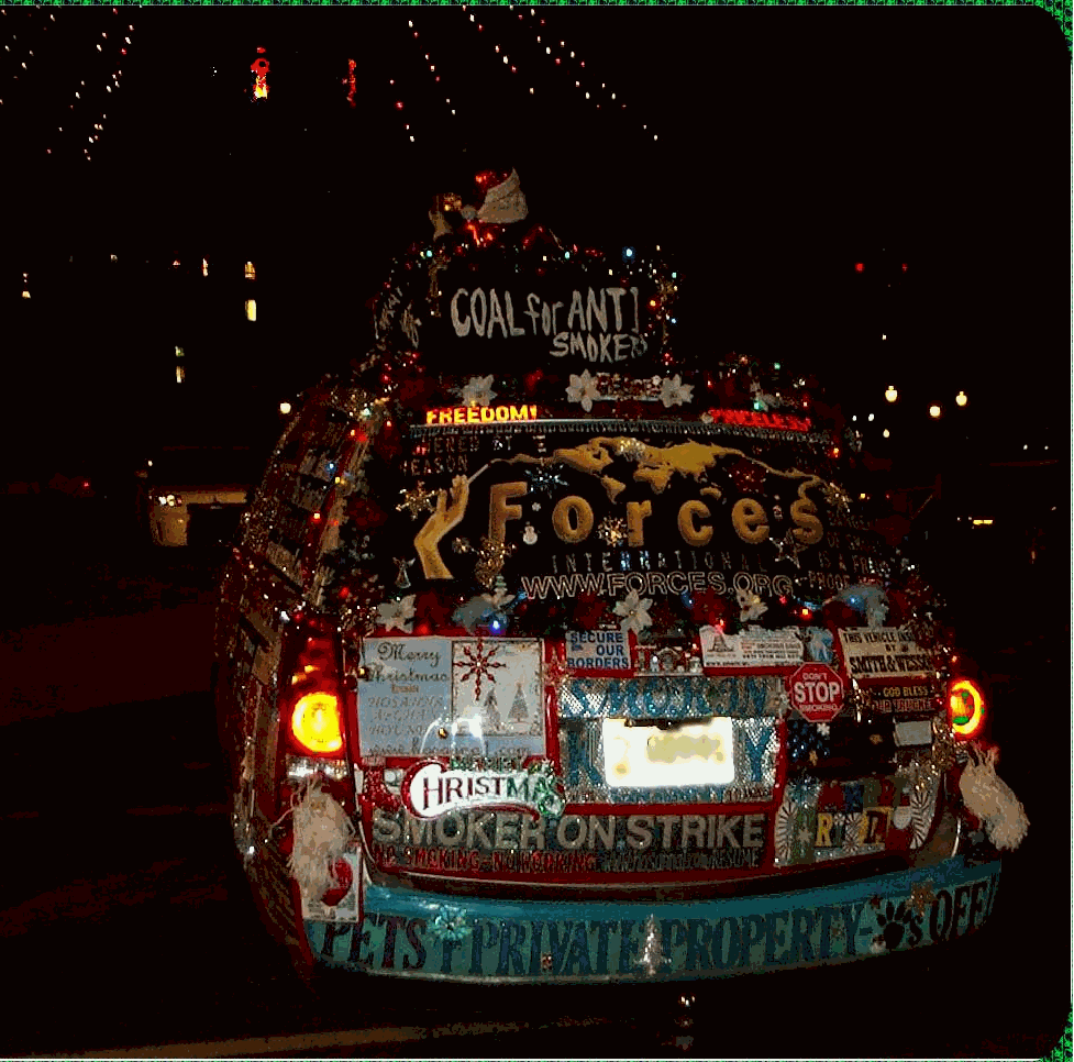 Close up photo of rear of Liberty Van aka smoker's rights van, with forces logo, and Christmas decorations - night picture with lights